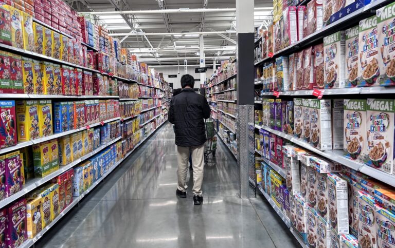 Male Instacart shopper at the supermarket (Ronaldo Schemidt / AFP / Getty Images)