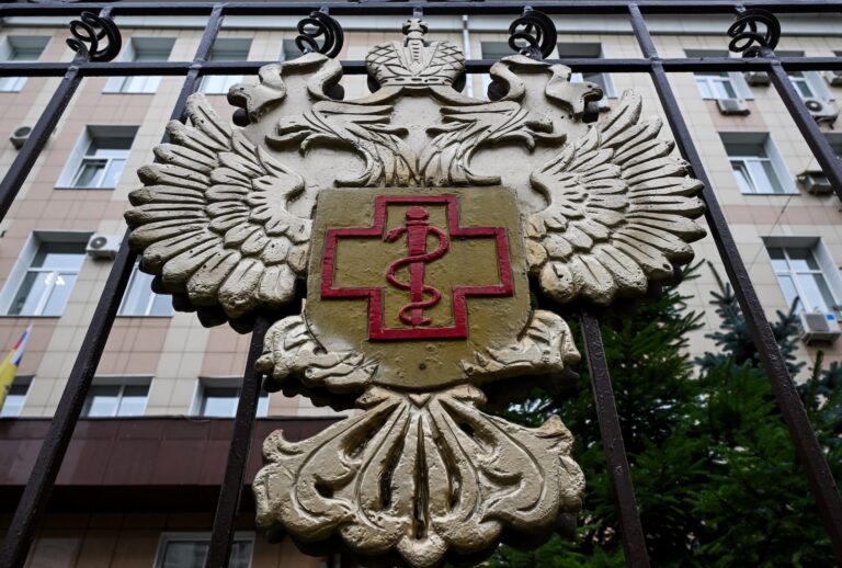 The logo of Russia's consumer and health watchdog Rospotrebnadzor sits on its grounds' fencing in Moscow on October 5, 2026. Russian officials on October 5, 2026 downplayed reports that a laboratory technician in Siberia had died of plague, insisting the situation was under control and that post-mortem tests had not found traces of the disease. (Photo by Igor IVANKO / AFP via Getty Images)